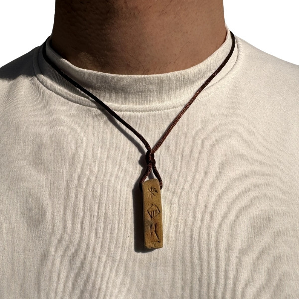 A Locally Handmade Cylindrical Necklace Engraved with The Word Enkidu in Cuneiform Inscriptions